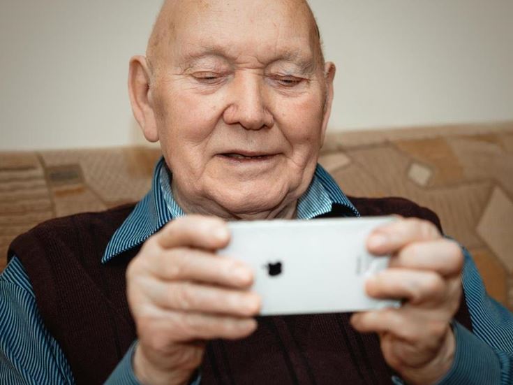 an older man looking at his phone