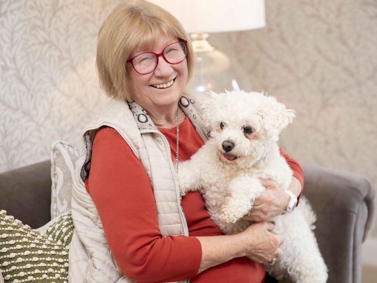 a woman holding a dog