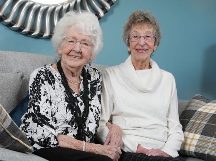 Dorothy Leake and Barbara Higginbotham sitting on sofa