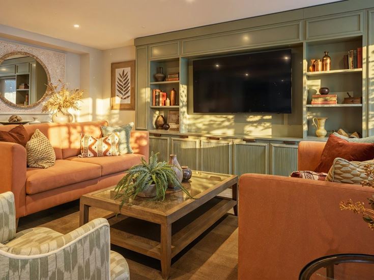 a living room with a tv and couches