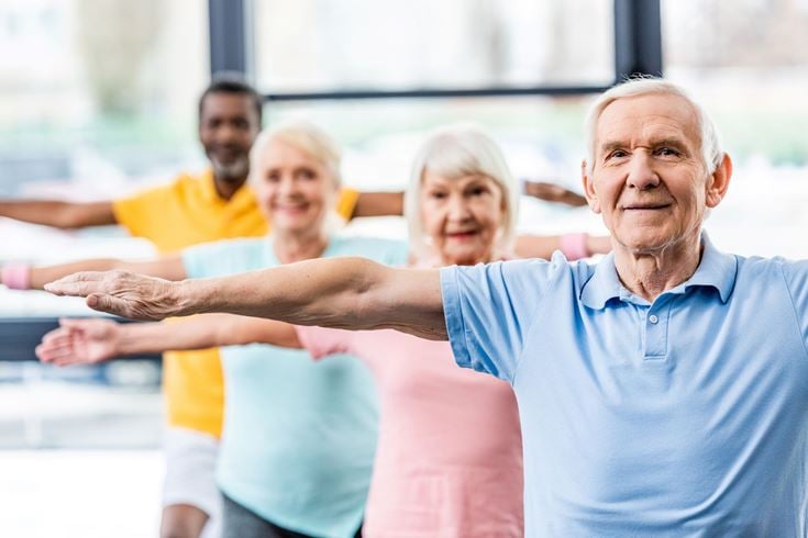 a group of people flexing their muscles
