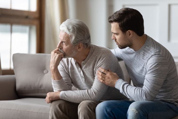 A younger family member comforts older person