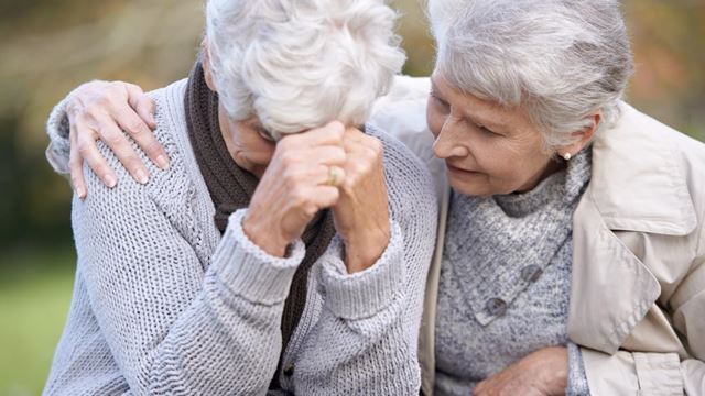 Grieving older woman coping after death of spouse