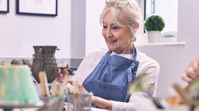 Woman makes a pottery vase in the craft room at her Retirement Living PLUS McCarthy & Stone retirement home