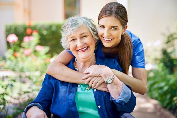 a person hugging a smiling woman