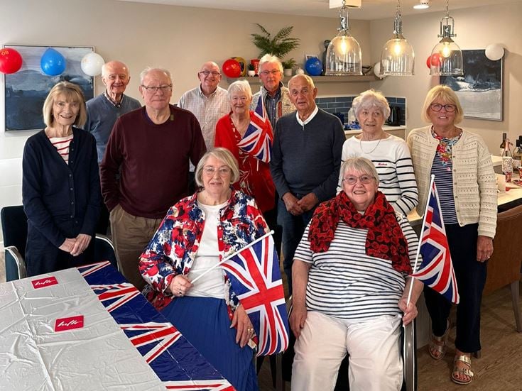 A group of retired people dressed up to commemorate VE day.