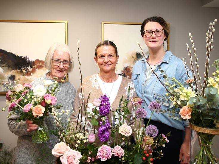 image of women holding flowers