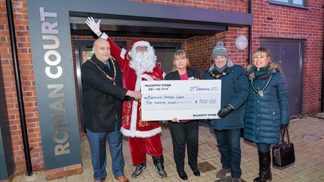 McCarthy & Stone Sales Consultant Kim Garbett and Santa handing over a cheque to Middlewich Town Council Deputy Mayor Simon Whittaker, Mayor Colin Coules and Mayoress Elena Coules