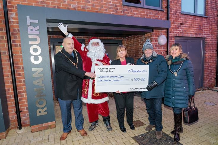 McCarthy & Stone Sales Consultant Kim Garbett and Santa handing over a cheque to Middlewich Town Council Deputy Mayor Simon Whittaker, Mayor Colin Coules and Mayoress Elena Coules