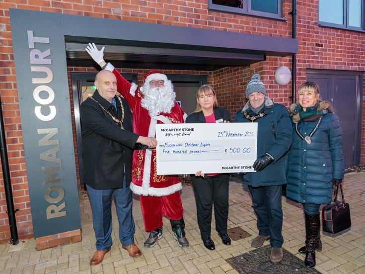 McCarthy & Stone Sales Consultant Kim Garbett and Santa handing over a cheque to Middlewich Town Council Deputy Mayor Simon Whittaker, Mayor Colin Coules and Mayoress Elena Coules