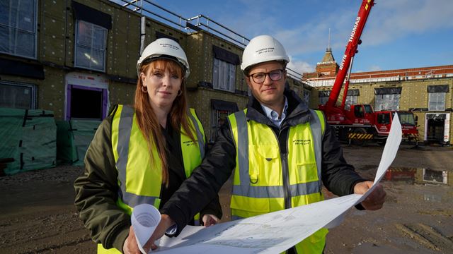 a couple of people wearing hardhats and hard hats