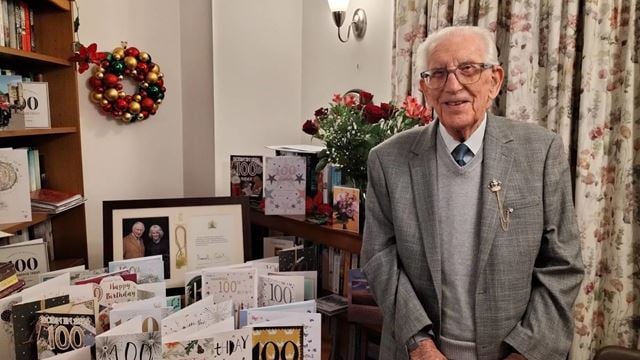 John celebrates 100 birthday in his McCarthy & Stone retirement living property Clevedon. He is shown with his 100 birthday cards