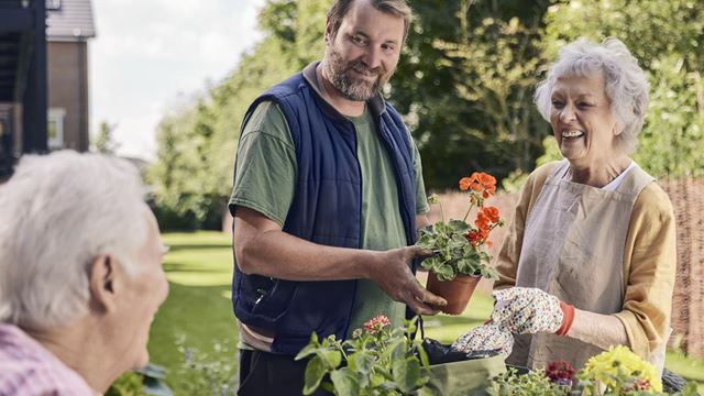 Gardener Adrian chats to homeowners in the shared gardens at our retirement homes in Olney, Buckinghamshire.