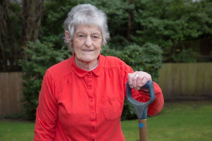 Professor Margaret Clark OBE holding a shovel in hand