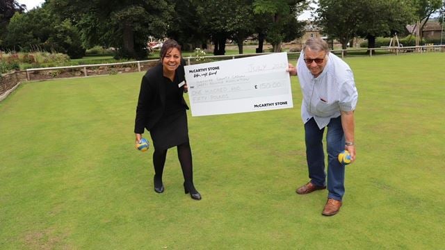 a man and woman standing next to a sign on a golf course