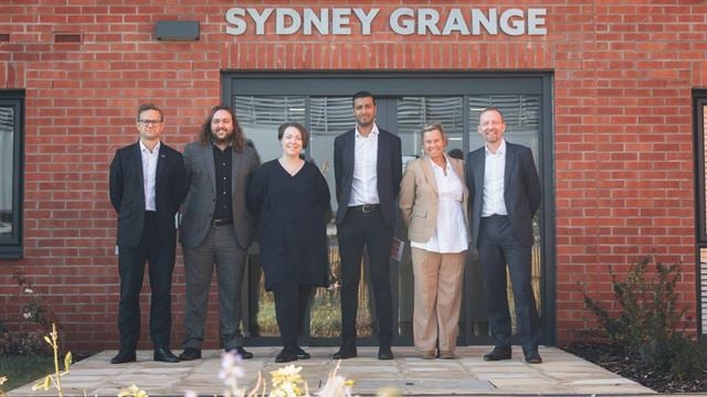 a group of people standing in front of a building