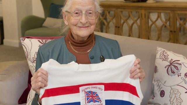 an old woman holding a flag
