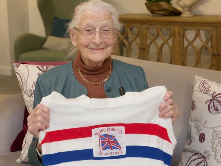 an old woman holding a flag
