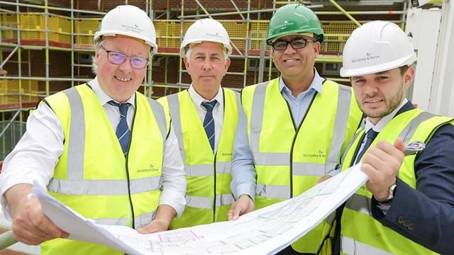 a group of men wearing hardhats and hard hats