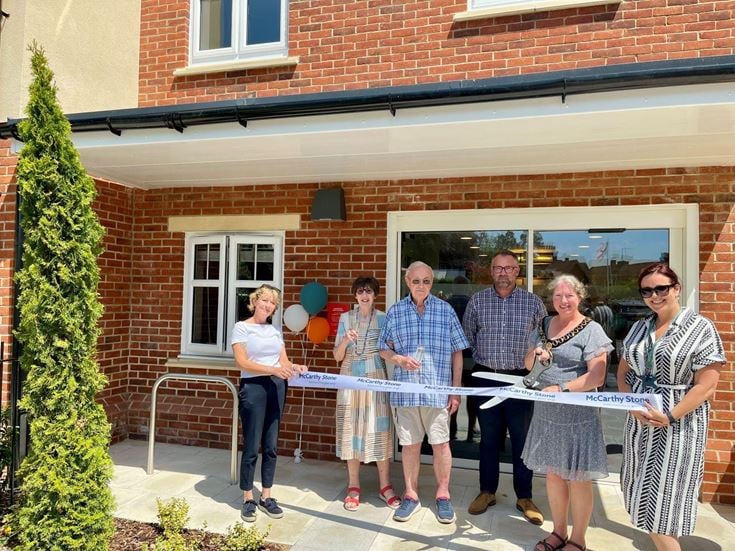 Councillor Penny Flux cutting the ribbon at the grand opening of Flora Place.
