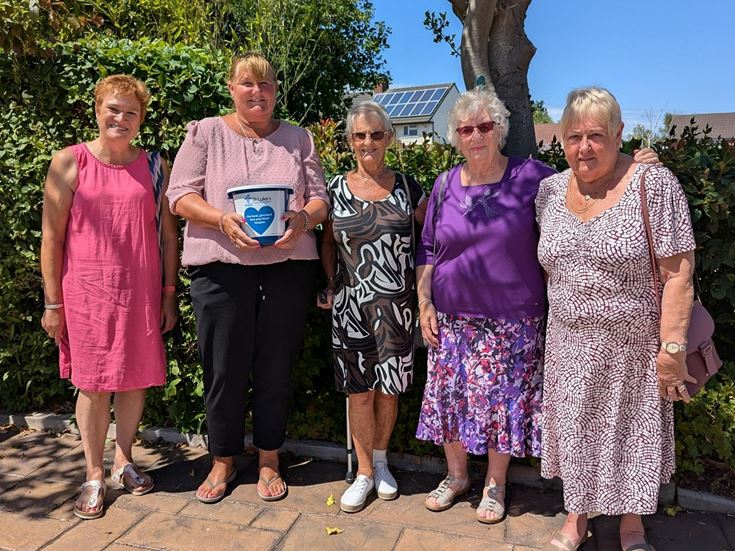 a group of women posing for a photo
