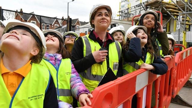 a group of people wearing safety vests
