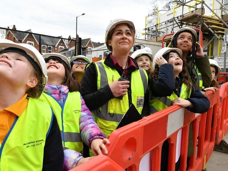a group of people wearing safety vests