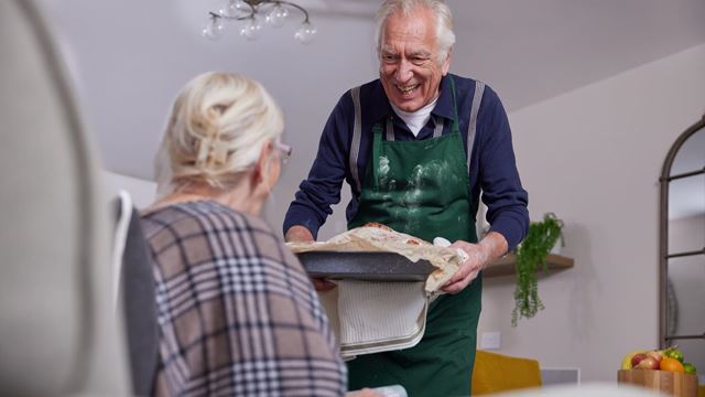 a man and a woman holding a tray of food