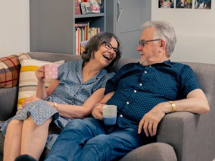 Mr and Mrs Gordon sitting on their couch