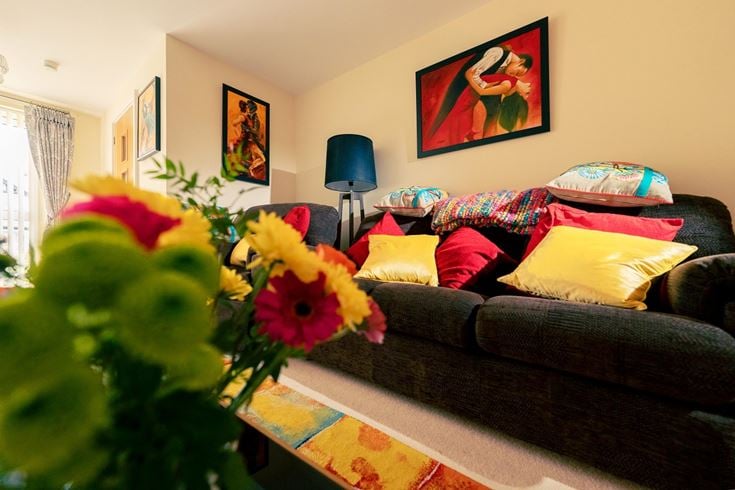 a living room with a couch and a lamp