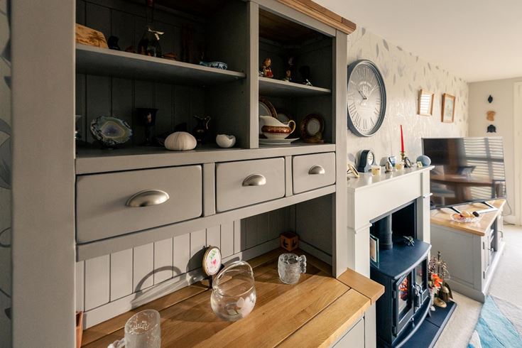 a kitchen with a table and shelves
