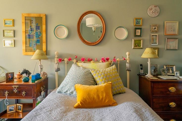 a bed with a flowery pillow