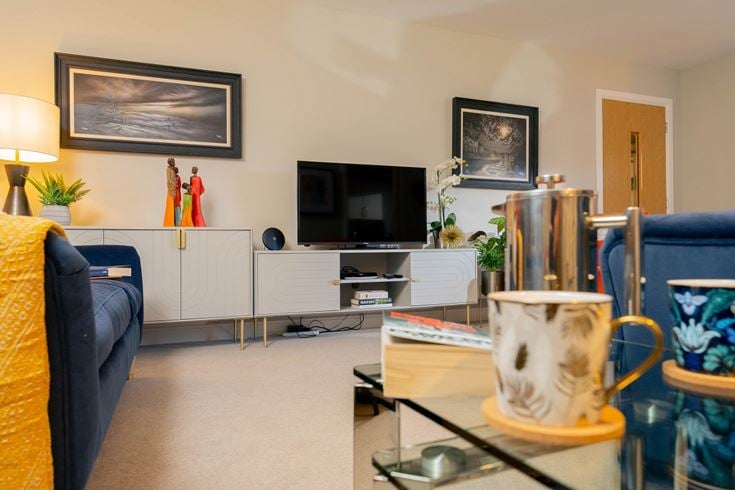 a living room with a tv and couches