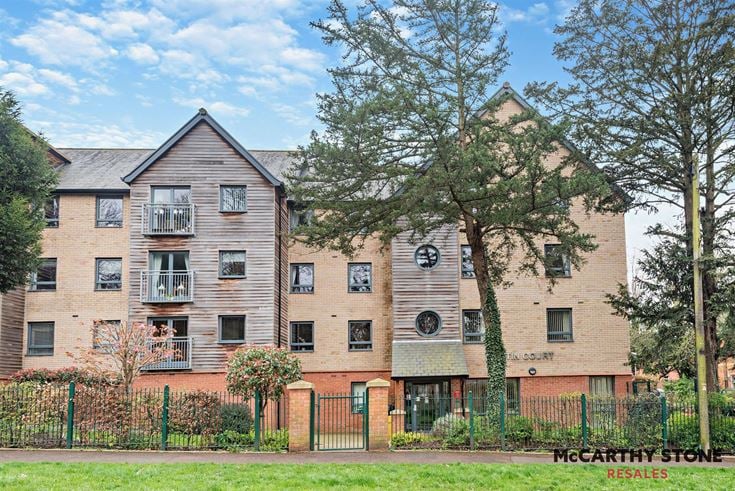 a large brick building with trees in front of it