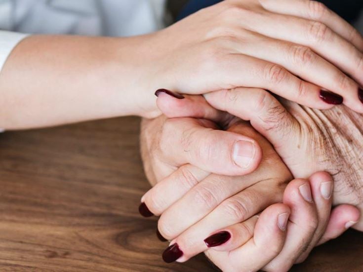a pair of hands holding each other