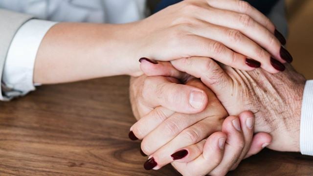 a pair of hands holding each other