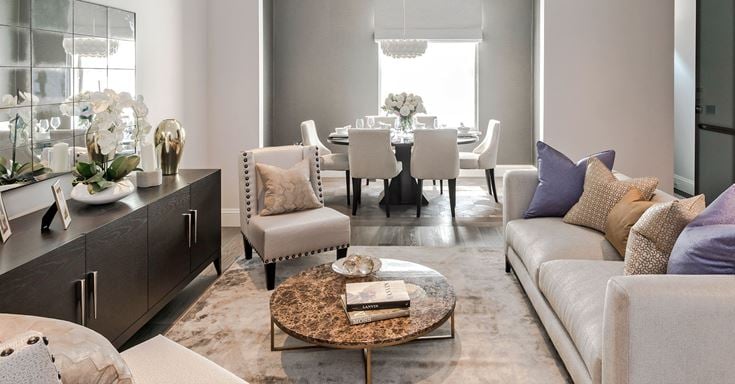 a living room with a table and chairs
