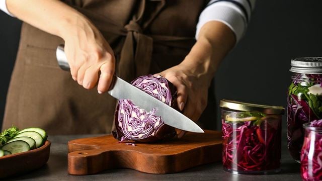 Preparing ingredients for sauerkraut on wooden chopping board