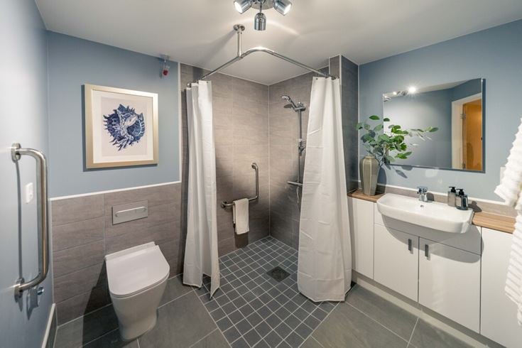a bathroom with a shower and sink