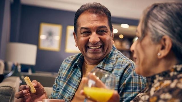 a man and a woman holding cups of liquid