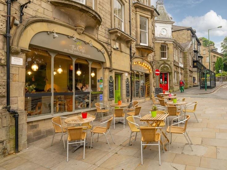 a group of tables and chairs outside a building