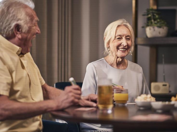 a man and a woman sitting at a table with drinks