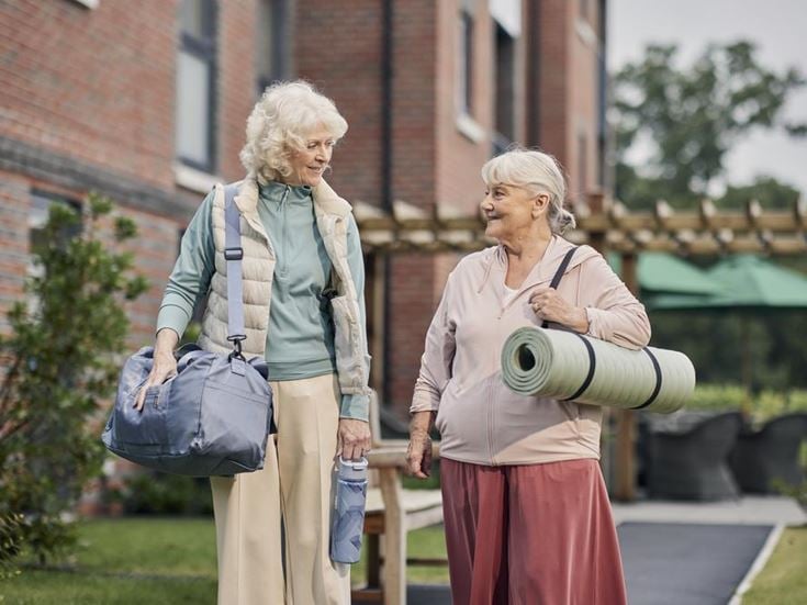 a couple of women walking