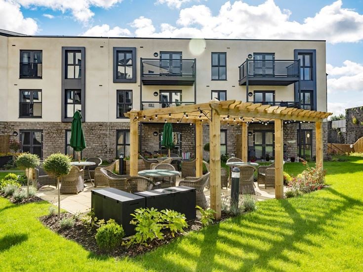 a building with a garden in front