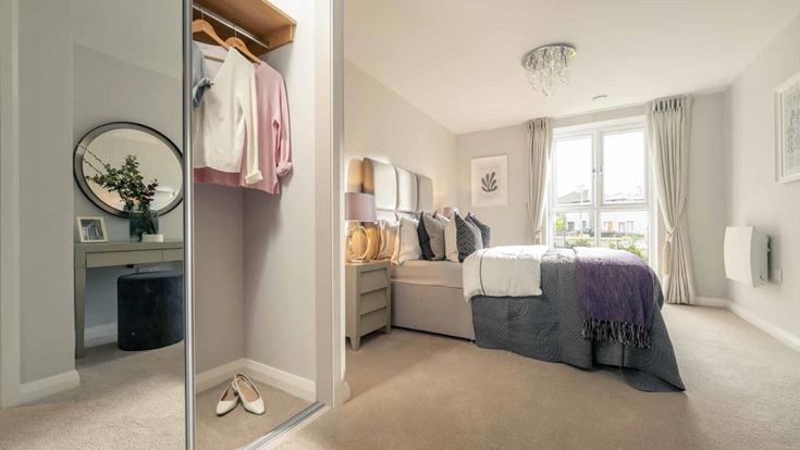 a bedroom with a bed and a mirror