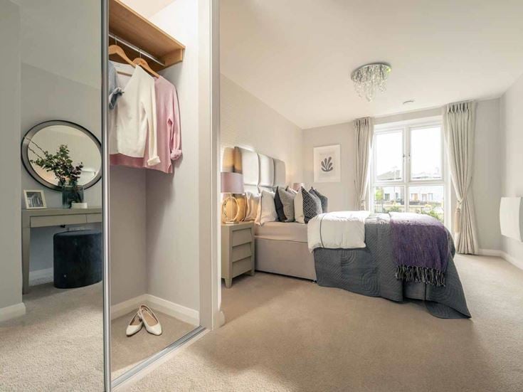 a bedroom with a bed and a mirror