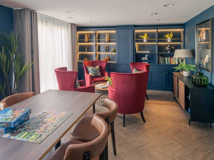 a living room with a table and chairs