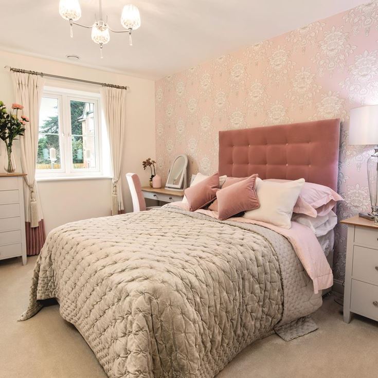 a bedroom with pink walls