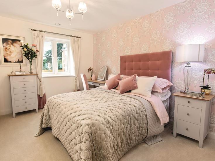 a bedroom with pink walls