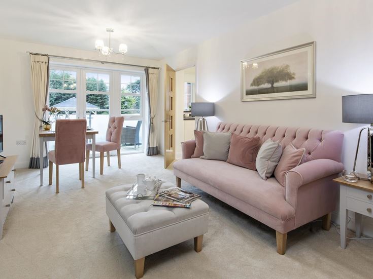 a living room with a pink couch